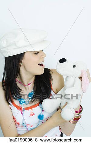 Stock Photo - Teen girl holding stuffed animal, portrait. Fotosearch