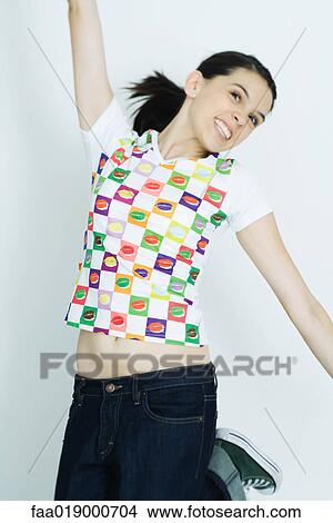 Picture - Teen girl jumping into the air. Fotosearch