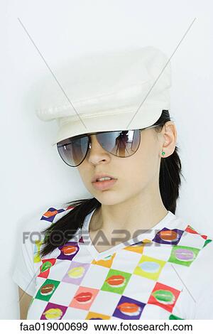 Teen girl wearing cap and sunglasses, portrait View Large Photo Image Stock Photo - Teen girl wearing cap and sunglasses, portrait. Fotosearch