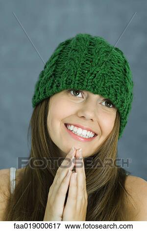 Teen girl wearing knit hat, hands clasped, portrait View Large Photo Image Stock Photo - Teen girl wearing knit hat, hands clasped, portrait. Fotosearch