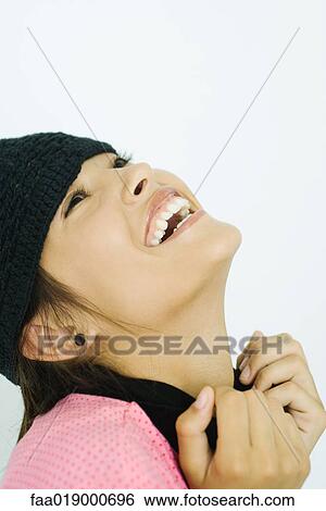 Teen girl wearing knit hat, head back, laughing, portrait View Large Photo Image Stock Photograph - Teen girl wearing knit hat, head back, laughing, portrait. Fotosearch
