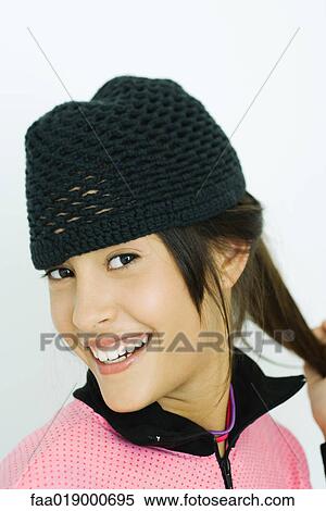 Teen girl wearing knit hat, portrait View Large Photo Image Stock Photography - Teen girl wearing knit hat, portrait. Fotosearch