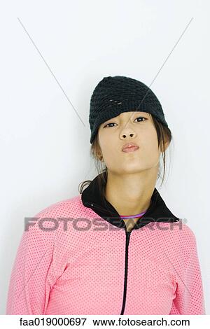 Teen girl wearing knit hat, puckering at camera, portrait View Large Photo Image Stock Photo - Teen girl wearing knit hat, puckering at camera, portrait. Fotosearch