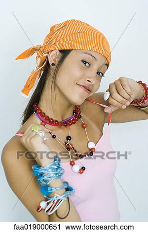 Teen girl wearing lots of accessories, hands up, smiling at camera, portrait View Large Photo Image Stock Image - Teen girl wearing lots of accessories, hands up, smiling at camera, portrait. Fotosearch