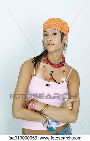 Teen girl wearing lots of accessories, arms folded, looking at camera, portrait View Large Photo Image Stock Photo - Teen girl wearing lots of accessories, arms folded, looking at camera, portrait. Fotosearch