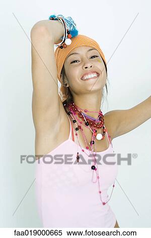 Teen girl wearing lots of accessories, arms up, smiling at camera, portrait View Large Photo Image Stock Photography - Teen girl wearing lots of accessories, arms up, smiling at camera, portrait. Fotosearch