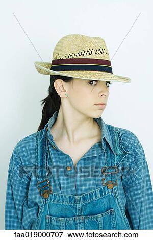 Teen girl wearing overalls and straw hat, portrait View Large Photo Image Stock Photo - Teen girl wearing overalls and straw hat, portrait. Fotosearch