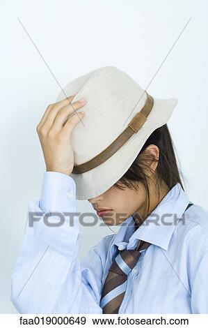 Teen girl wearing shirt, tie, and hat, pulling hat down over eyes View Large Photo Image Stock Photo - Teen girl wearing shirt, tie, and hat, pulling hat down over eyes. Fotosearch