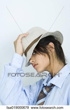 Teen girl wearing shirt, tie and hat, peeking at camera, portrait View Large Photo Image Stock Photo - Teen girl wearing shirt, tie and hat, peeking at camera, portrait. Fotosearch