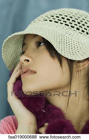 Teen girl wearing sun hat and fur scarf, holding fur to face, close-up, portrait View Large Photo Image Stock Photo - Teen girl wearing sun hat and fur scarf, holding fur to face, close-up, portrait. Fotosearch