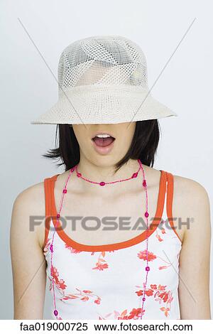 Teen girl wearing sun hat, eyes covered, portrait View Large Photo Image Stock Photography - Teen girl wearing sun hat, eyes covered, portrait. Fotosearch