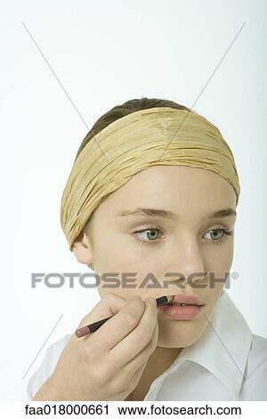 Teenage girl applying lipliner View Large Photo Image Stock Image - Teenage girl applying lipliner. Fotosearch