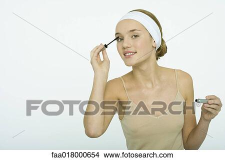 Picture - Teenage girl applying mascara. Fotosearch