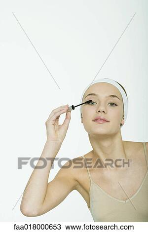 Teenage girl applying mascara View Large Photo Image Stock Image - Teenage girl applying mascara. Fotosearch