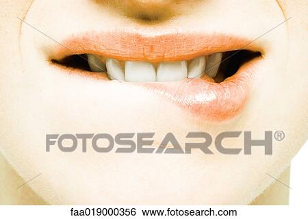 Teenage girl biting lip, extreme close-up View Large Photo Image Stock Photograph - Teenage girl biting lip, extreme close-up. Fotosearch