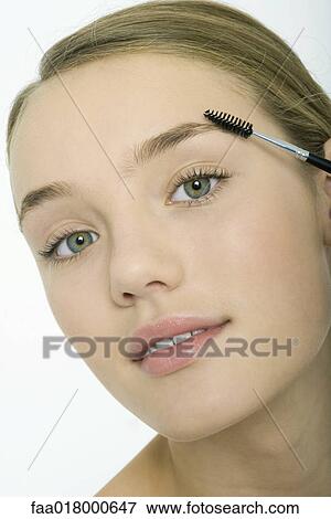 Teenage girl brushing eyebrows View Large Photo Image Stock Photo - Teenage girl brushing eyebrows. Fotosearch