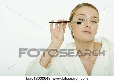 Teenage girl brushing eyelashes View Large Photo Image Stock Photo - Teenage girl brushing eyelashes. Fotosearch