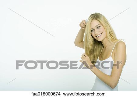 Teenage girl combing hair View Large Photo Image Picture - Teenage girl combing hair. Fotosearch