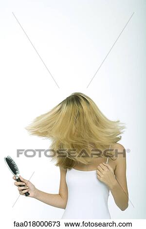 Teenage girl holding brush, swinging hair View Large Photo Image Stock Image - Teenage girl holding brush, swinging hair. Fotosearch