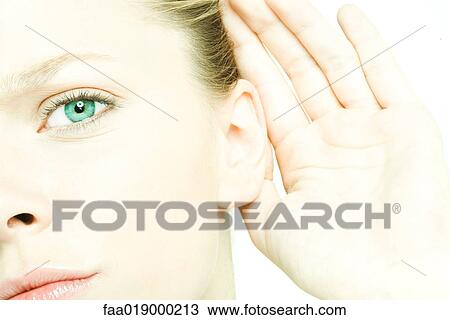 Teenage girl holding hand behind ear, looking at camera, close-up View Large Photo Image Stock Image - Teenage girl holding hand behind ear, looking at camera, close-up. Fotosearch