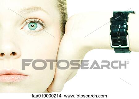 Teenage girl holding hand over ear, looking straight ahead, close-up View Large Photo Image Picture - Teenage girl holding hand over ear, looking straight ahead, close-up. Fotosearch