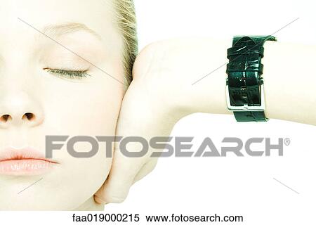 Teenage girl holding hand over ear, eyes closed, close-up View Large Photo Image Stock Photography - Teenage girl holding hand over ear, eyes closed, close-up. Fotosearch