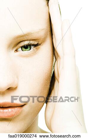 Teenage girl rubbing temple, extreme close-up View Large Photo Image Picture - Teenage girl rubbing temple, extreme close-up. Fotosearch