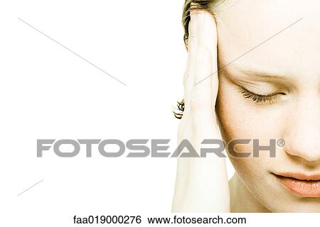 Teenage girl rubbing temple, extreme close-up View Large Photo Image Stock Photograph - Teenage girl rubbing temple, extreme close-up. Fotosearch