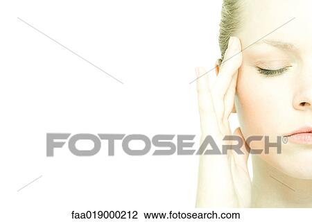 Teenage girl rubbing temple, eyes closed, close-up View Large Photo Image Stock Image - Teenage girl rubbing temple, eyes closed, close-up. Fotosearch