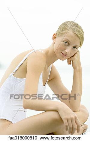 Teenage girl sitting indian style, leaning on elbow, smiling at camera View Large Photo Image Stock Image - Teenage girl sitting indian style, leaning on elbow, smiling at camera. Fotosearch