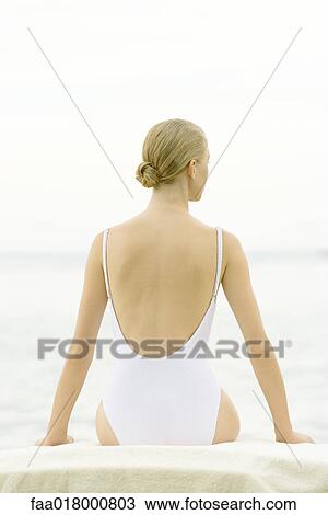 Teenage girl sitting, wearing bathing suit, rear view View Large Photo Image Stock Image - Teenage girl sitting, wearing bathing suit, rear view. Fotosearch