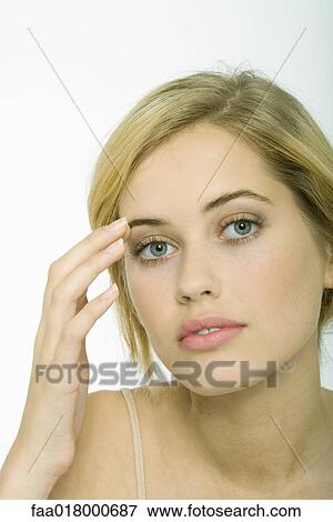 Teenage girl touching eyebrow View Large Photo Image Stock Photo - Teenage girl touching eyebrow. Fotosearch