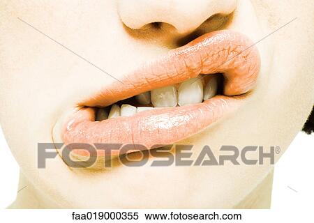 Stock Photography - Teenage girl twisting mouth, extreme close-up. Fotosearch