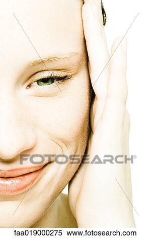 Stock Photography - Teenage girl's face, hand on temple, extreme close-up. Fotosearch