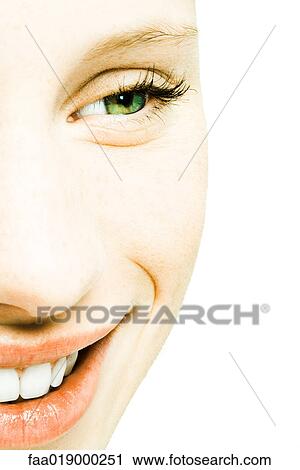 Stock Image - Teenage girl's face, smiling, extreme close-up. Fotosearch