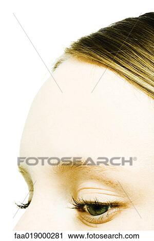 Stock Image - Teenage girl's forehead and eyes, close-up. Fotosearch