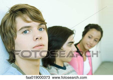Three teen friends, focus on teen boy in foreground View Large Photo Image Stock Image - Three teen friends, focus on teen boy in foreground. Fotosearch