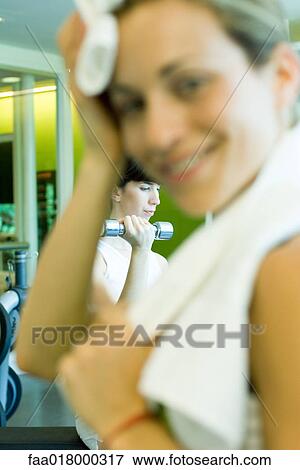 Two women in weight room, woman in foreground with towel around neck View Large Photo Image Stock Photo - Two women in weight room, woman in foreground with towel around neck. Fotosearch