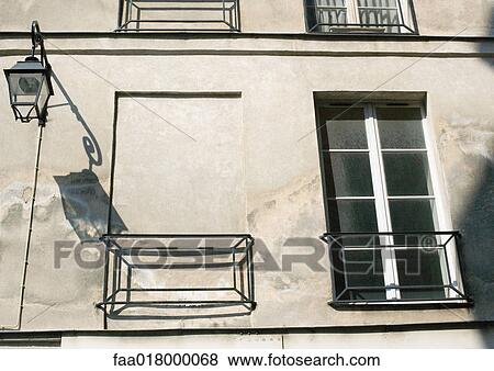 Windows in apartment building, one window filled in with concrete View Large Photo Image Stock Photo - Windows in apartment building, one window filled in with concrete. Fotosearch
