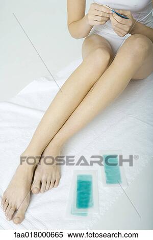 Woman applying cold wax strips, chest down View Large Photo Image Stock Photography - Woman applying cold wax strips, chest down. Fotosearch