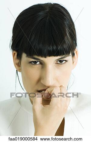 Woman biting fingers, portrait View Large Photo Image Picture - Woman biting fingers, portrait. Fotosearch