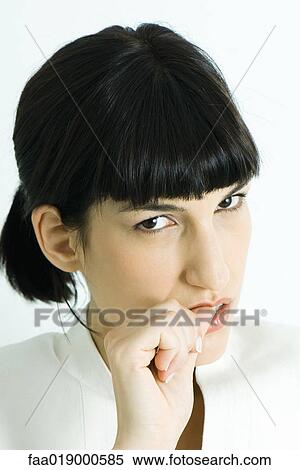 Woman biting thumb, portrait View Large Photo Image Stock Photography - Woman biting thumb, portrait. Fotosearch
