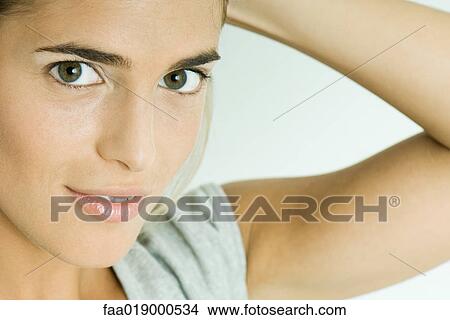 Picture - Woman, hand behind head, close-up, portrait. Fotosearch