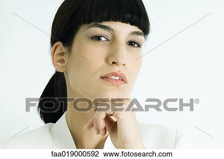 Stock Image - Woman, hand under chin, portrait. Fotosearch