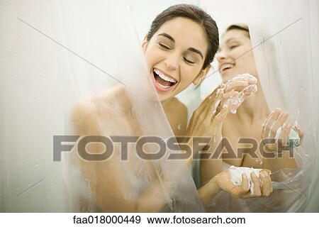 Stock Photo - Woman handing friend soap in public showers. Fotosearch