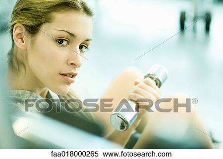 Woman holding dumbbell View Large Photo Image Stock Photography - Woman holding dumbbell. Fotosearch