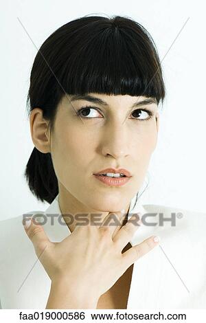 Woman holding hand under chin, looking away, portrait View Large Photo Image Stock Photograph - Woman holding hand under chin, looking away, portrait. Fotosearch