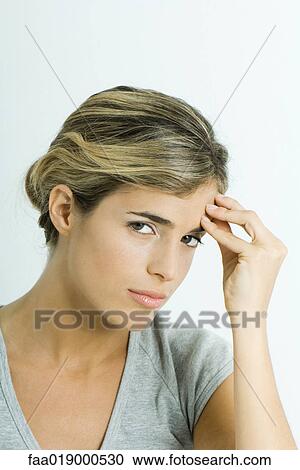 Woman, holding head, looking at camera, portrait View Large Photo Image Stock Image - Woman, holding head, looking at camera, portrait. Fotosearch