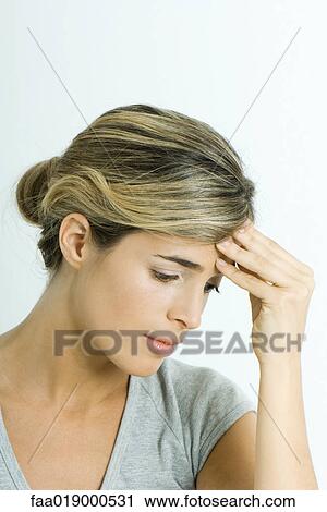 Stock Image - Woman, holding head, portrait. Fotosearch