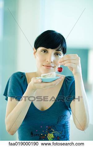 Woman holding up fresh cherry in one hand and saucer with finger sandwiches in the other hand View Large Photo Image Stock Image - Woman holding up fresh cherry in one hand and saucer with finger sandwiches in the other hand. Fotosearch